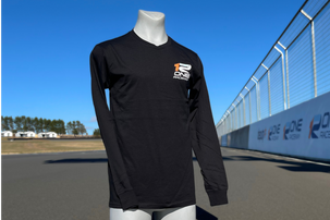 Black long-sleeve shirt with a logo on a mannequin against a race track background